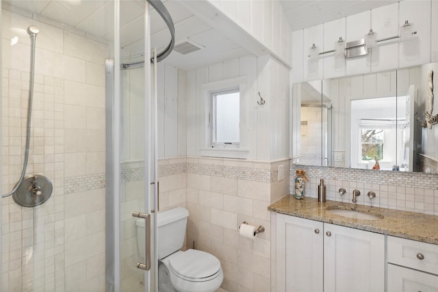 67 N Rd Unit A, Hampton Bays, NY 11946 - full bath with a stall shower, vanity, plenty of natural light, toilet, and tile walls