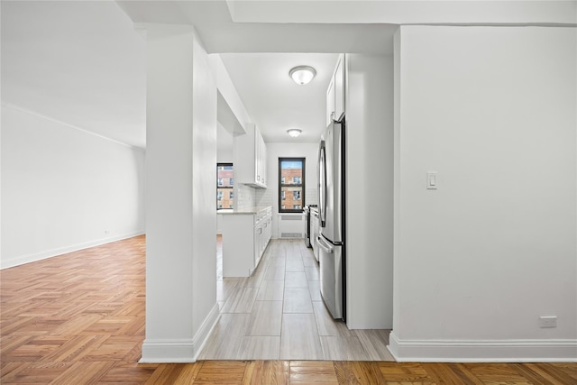 hall featuring baseboards