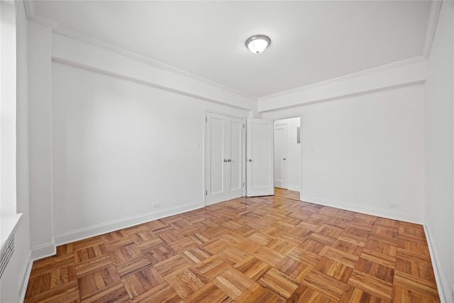 unfurnished room featuring crown molding and baseboards