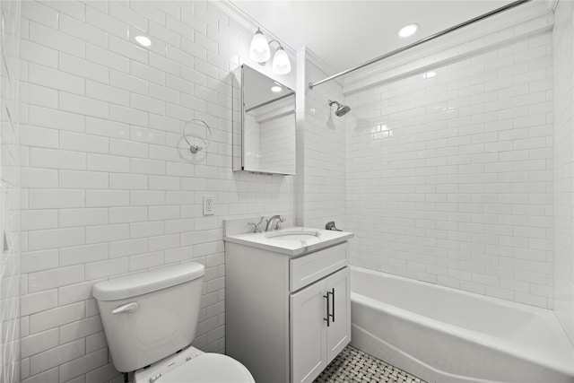 bathroom featuring tub / shower combination, toilet, tile walls, tile patterned flooring, and vanity