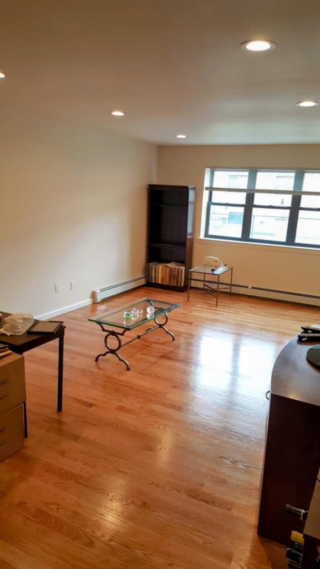 14 Florence Unit 25D, Freeport, NY 11520 - living room with a baseboard radiator, light wood-type flooring, recessed lighting, and baseboards