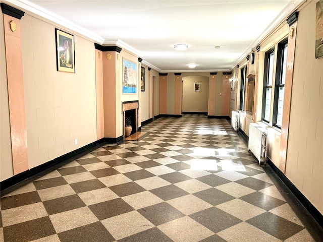 62-64 Saunders St Unit 3H, Rego Park, NY 11374 - corridor featuring radiator, dark floors, ornamental molding, arched walkways, and baseboards