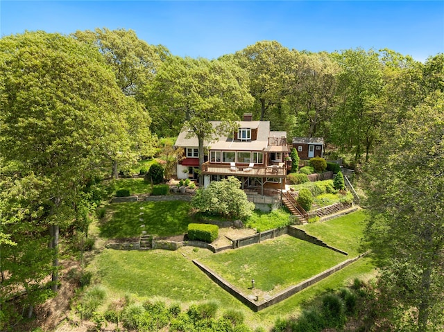 3 Summit Dr, Baiting Hollow, NY 11933 - back of house with a view of trees, a wooden deck, a chimney, and a yard