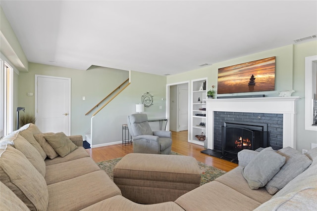 3 Summit Dr, Baiting Hollow, NY 11933 - living room with stairs, a fireplace, wood finished floors, and baseboards