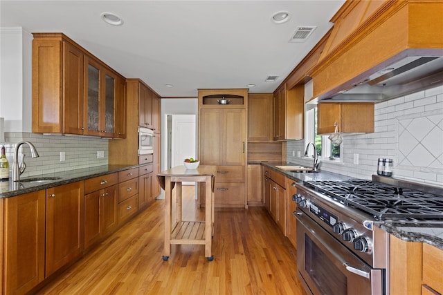 3 Summit Dr, Baiting Hollow, NY 11933 - kitchen with a sink, stainless steel range, brown cabinetry, and recessed lighting