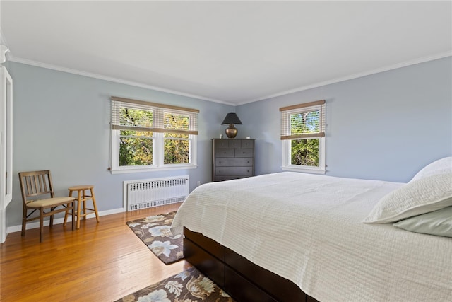 3 Summit Dr, Baiting Hollow, NY 11933 - bedroom featuring radiator heating unit, wood finished floors, crown molding, and baseboards