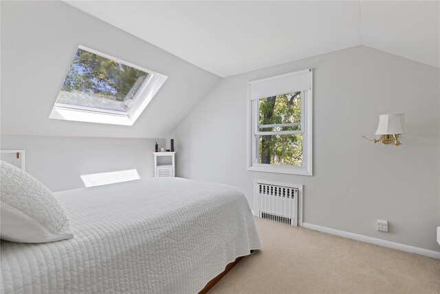 3 Summit Dr, Baiting Hollow, NY 11933 - carpeted bedroom with radiator heating unit, lofted ceiling, a skylight, and baseboards