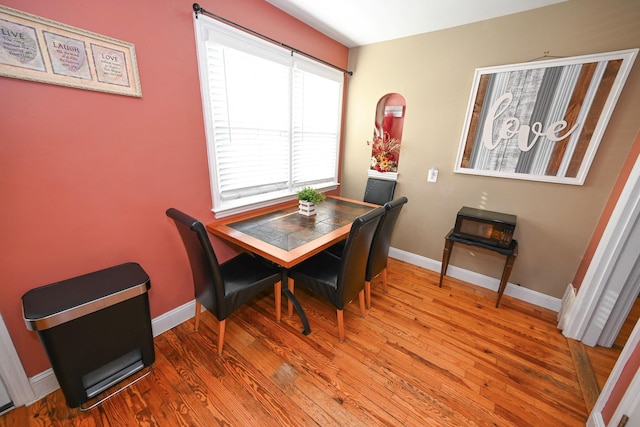 dining area with wood finished floors and baseboards