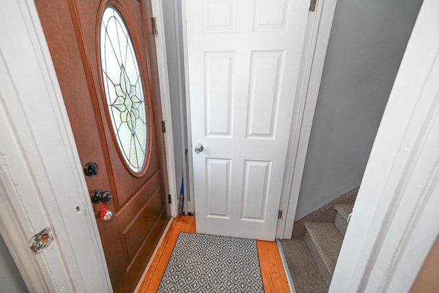 entryway with light wood finished floors and stairs