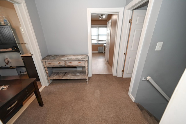 hallway with radiator heating unit, carpet, an upstairs landing, and an office area