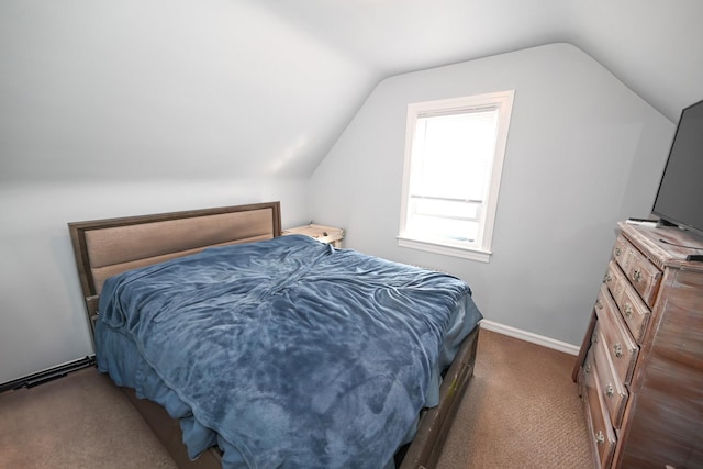 carpeted bedroom featuring lofted ceiling and baseboards