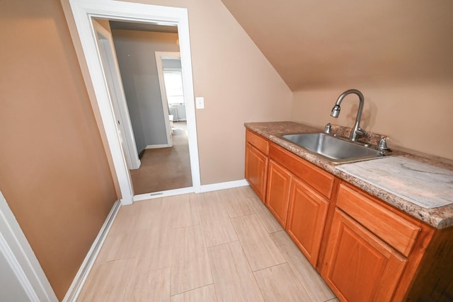 bar with a sink and baseboards