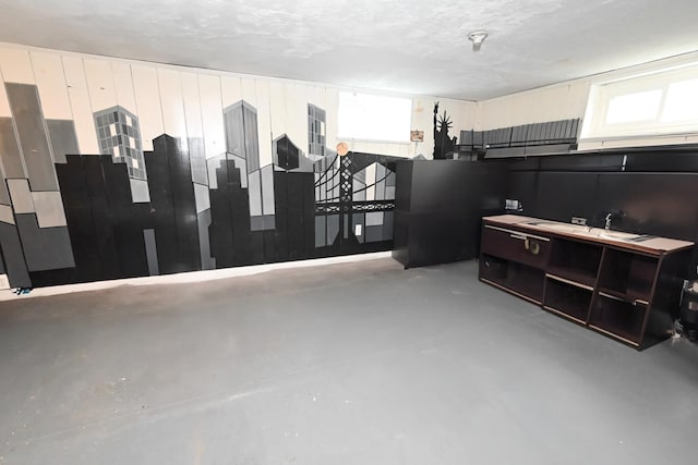 miscellaneous room featuring healthy amount of natural light and finished concrete floors