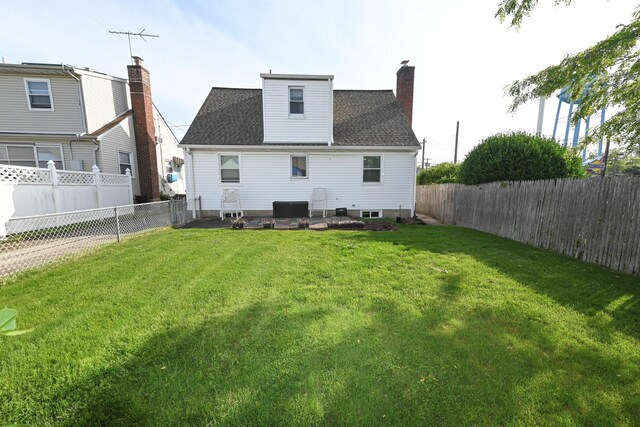 rear view of property with a chimney and roof with shingles