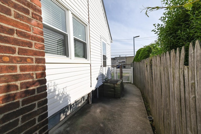 view of side of home featuring fence