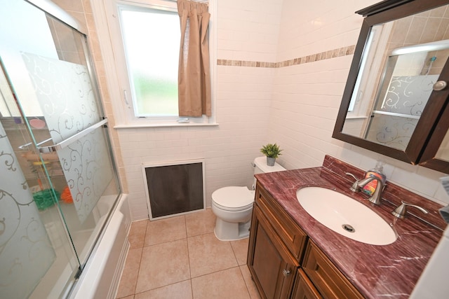 full bathroom with vanity, tile patterned floors, toilet, and bath / shower combo with glass door