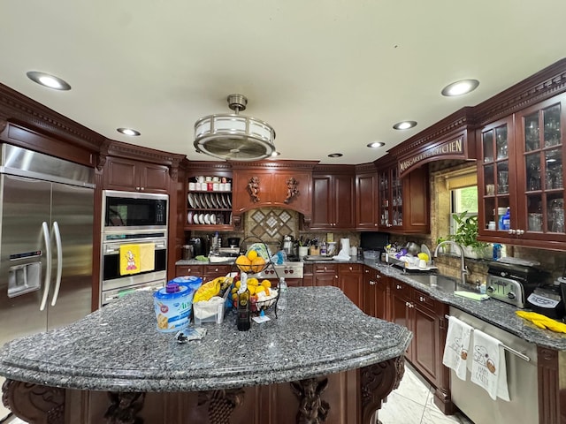 20-42 26th St, Astoria, NY 11105 - kitchen featuring built in appliances, a sink, backsplash, recessed lighting, and glass insert cabinets