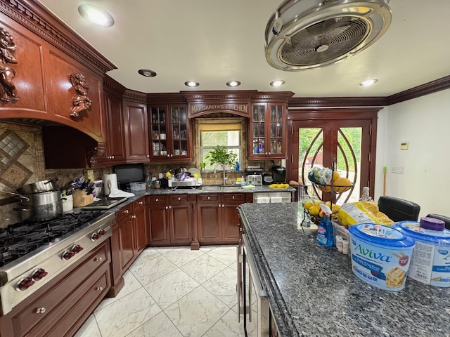 20-42 26th St, Astoria, NY 11105 - kitchen featuring light marble finish floors, stainless steel gas stovetop, a sink, backsplash, and glass insert cabinets