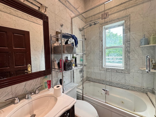 20-42 26th St, Astoria, NY 11105 - bathroom featuring a combined bath / shower with jetted tub, tile walls, vanity, and toilet