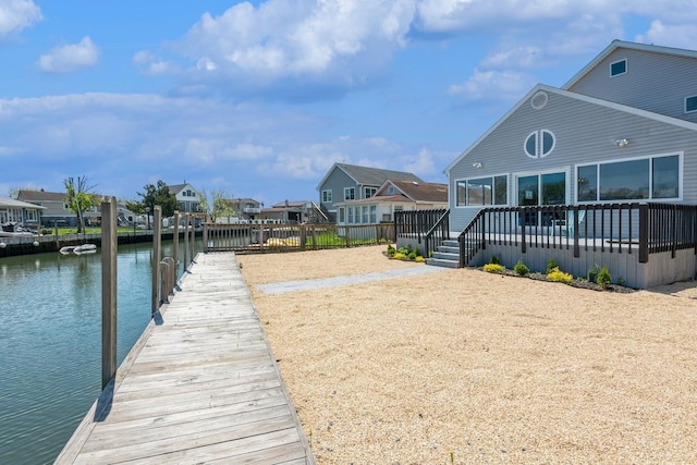 dock with a water view and a residential view