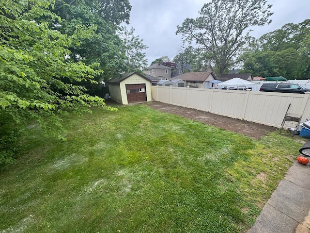 112 E Seaman Ave E, Freeport, NY 11520 - view of yard featuring a garage, an outbuilding, and driveway