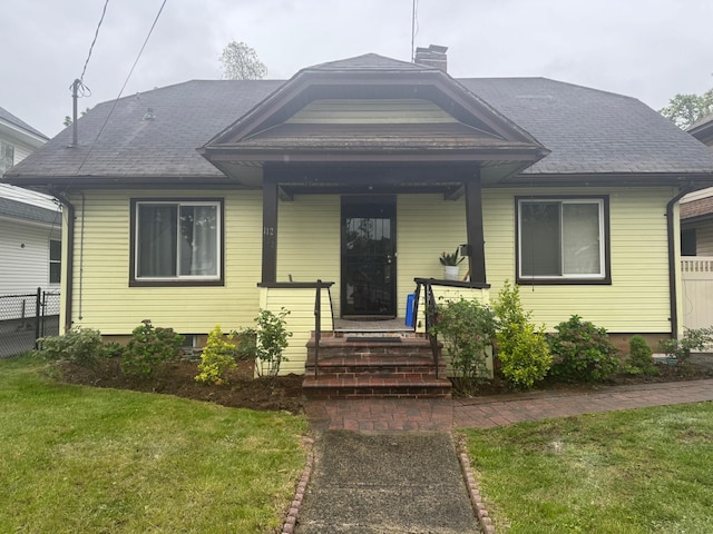 112 E Seaman Ave E, Freeport, NY 11520 - bungalow featuring a chimney, a shingled roof, and a porch