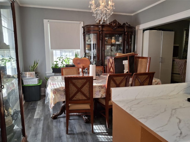 112 E Seaman Ave E, Freeport, NY 11520 - dining room featuring wood finished floors, a chandelier, and ornamental molding