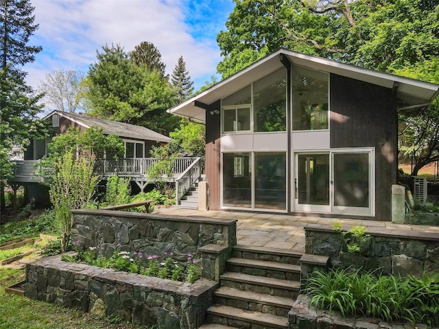14 Lounsbury Rd, Croton-On-Hudson, NY 10520 - back of property with stairway and a wooden deck