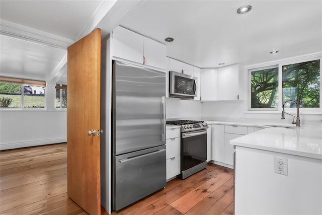 14 Lounsbury Rd, Croton-On-Hudson, NY 10520 - kitchen with stainless steel appliances, a sink, plenty of natural light, white cabinets, and recessed lighting