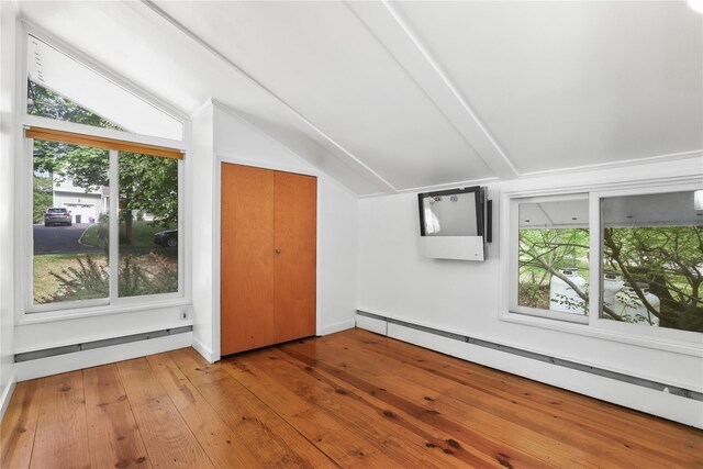14 Lounsbury Rd, Croton-On-Hudson, NY 10520 - additional living space with a baseboard radiator, lofted ceiling, healthy amount of natural light, and hardwood / wood-style flooring