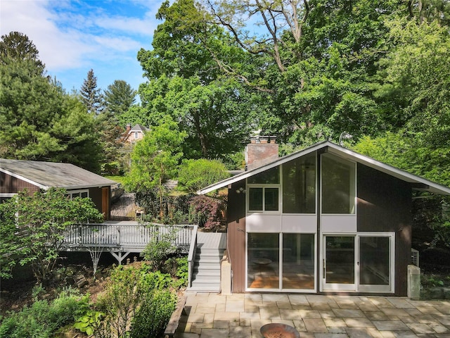 14 Lounsbury Rd, Croton-On-Hudson, NY 10520 - rear view of property featuring a wooden deck, a chimney, stairs, and a patio area