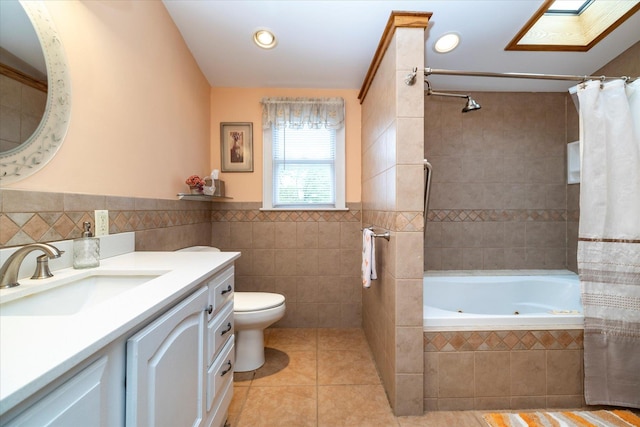 19 Croyden St, New Hyde Park, NY 11040 - full bath featuring tile walls, tile patterned flooring, toilet, a jetted tub, and vanity