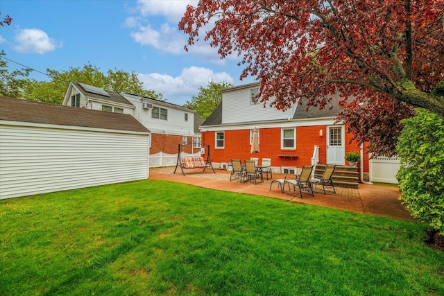 19 Croyden St, New Hyde Park, NY 11040 - back of property featuring a patio, an outbuilding, brick siding, and a shed