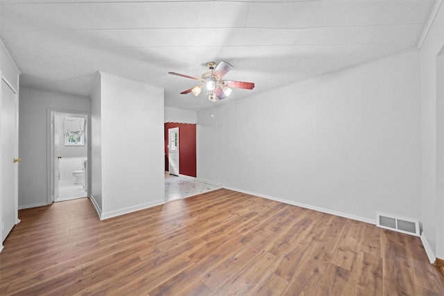 empty room featuring ceiling fan, wood finished floors, and baseboards
