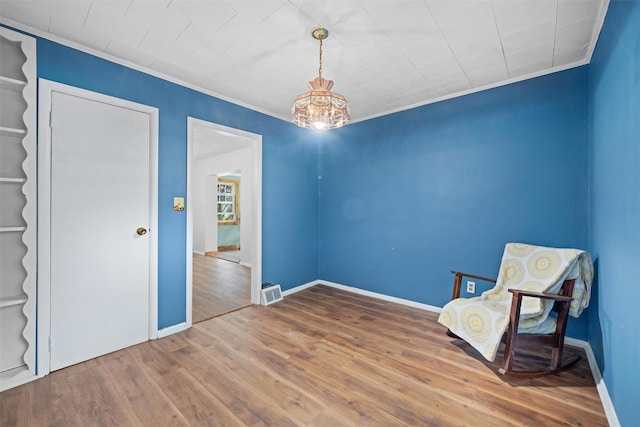 unfurnished room with crown molding, baseboards, and wood finished floors