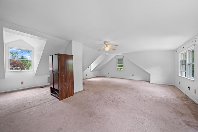 bonus room with carpet floors, lofted ceiling, plenty of natural light, and a ceiling fan