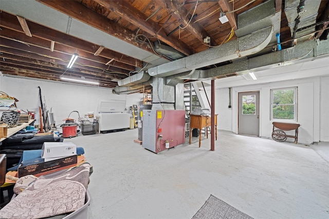 basement with stairway and heating unit