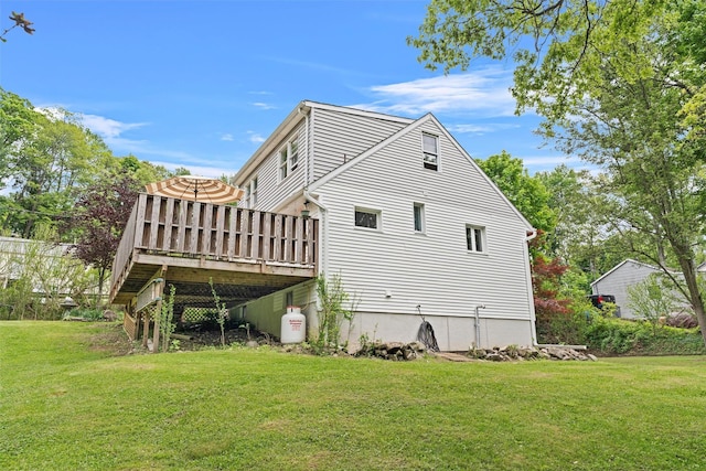 view of home's exterior featuring a lawn and a deck