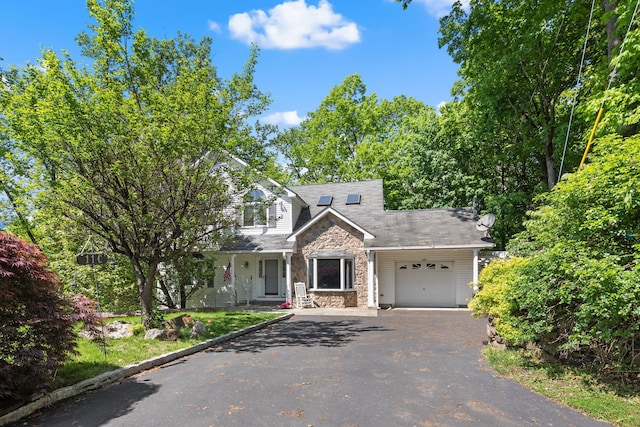 11C Piping Rock Dr, Ossining, NY 10562 - view of front facade with stone siding, asphalt driveway, and an attached garage