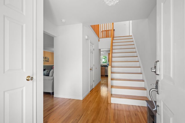 11C Piping Rock Dr, Ossining, NY 10562 - staircase featuring wood finished floors, baseboards, and a chandelier