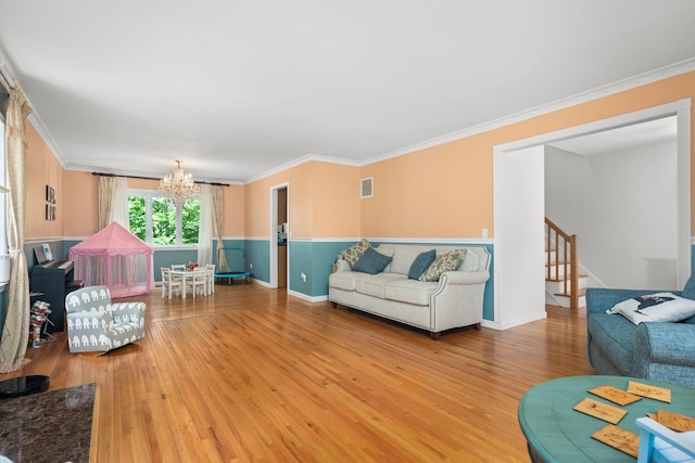 11C Piping Rock Dr, Ossining, NY 10562 - living room with a chandelier, wood finished floors, ornamental molding, baseboards, and stairway