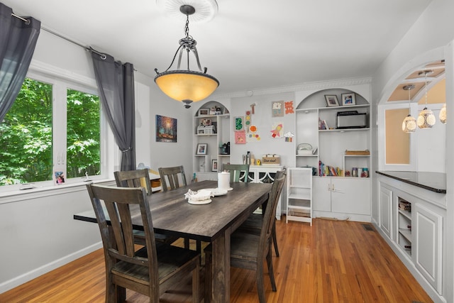 11C Piping Rock Dr, Ossining, NY 10562 - dining area featuring built in features, wood finished floors, and baseboards