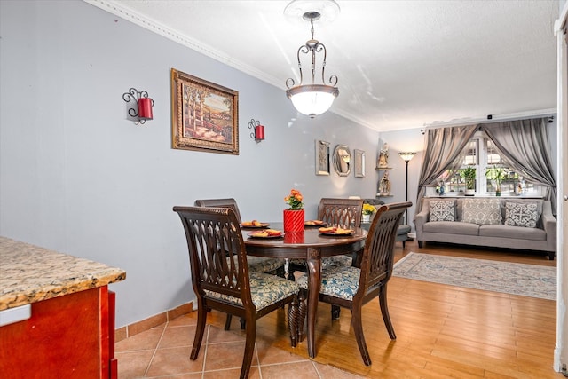 dining area featuring crown molding and baseboards