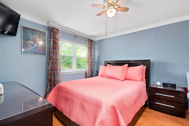 bedroom featuring wood finished floors and ceiling fan