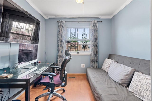 home office with wood finished floors, healthy amount of natural light, ornamental molding, and baseboards