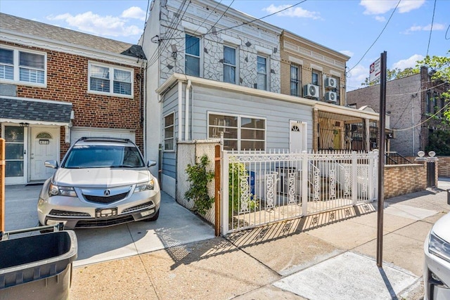 477 Berriman St, Brooklyn, NY 11208 - view of property with a fenced front yard, brick siding, and ac unit