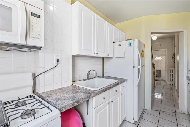 477 Berriman St, Brooklyn, NY 11208 - kitchen featuring white appliances, a sink, white cabinets, and light tile patterned floors
