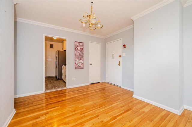 85-10 151st Ave Unit 5E, Howard Beach, NY 11414 - spare room with a chandelier, light wood-style floors, crown molding, and baseboards