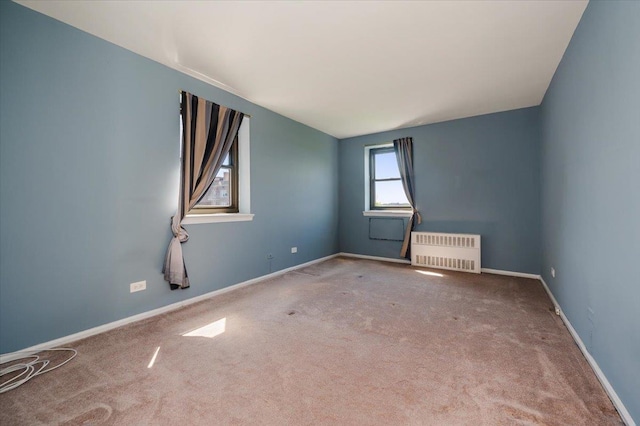 85-10 151st Ave Unit 5E, Howard Beach, NY 11414 - spare room with radiator heating unit, carpet, and baseboards