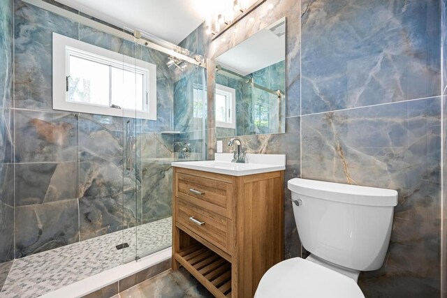 10 Shinnecock Ln, Hampton Bays, NY 11946 - full bath featuring tile walls, a shower stall, toilet, and vanity